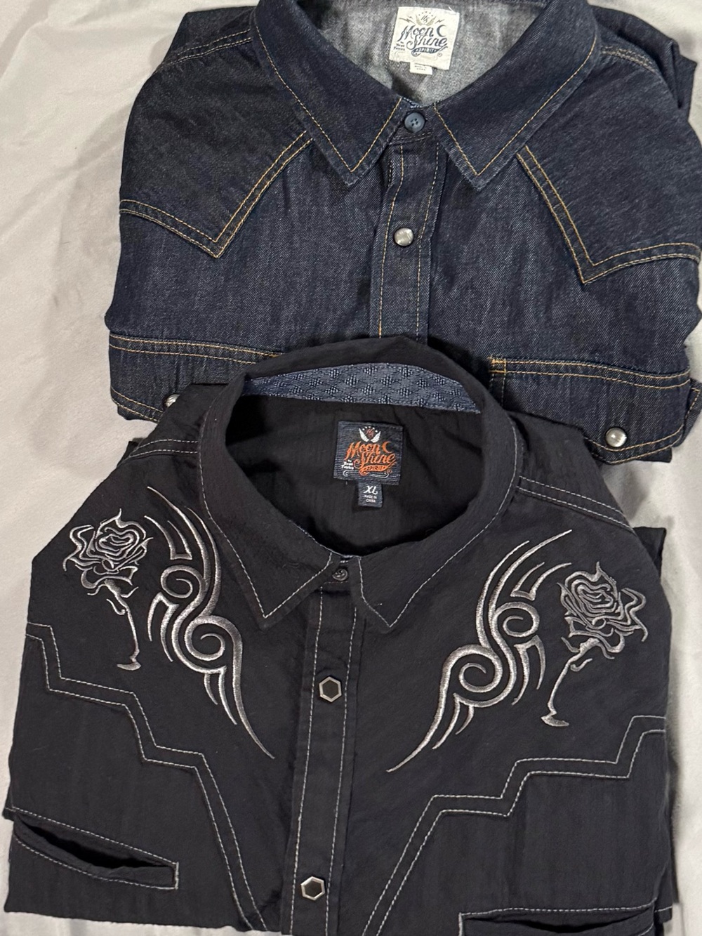 Lot Of 2 Men’s XL Moonshine Black Embroidered & Blue Denim Pearl Snap Shirts